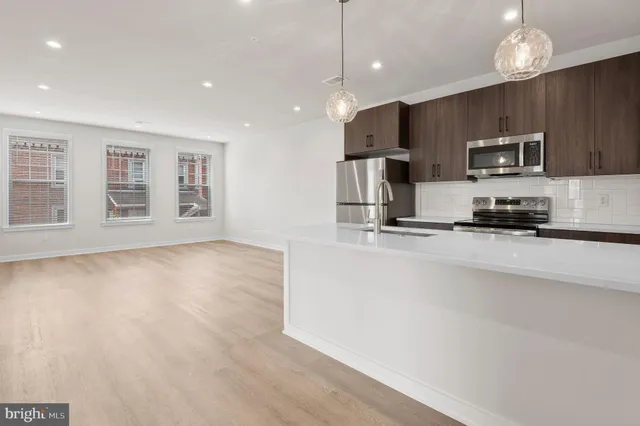 a kitchen with a sink and chandelier