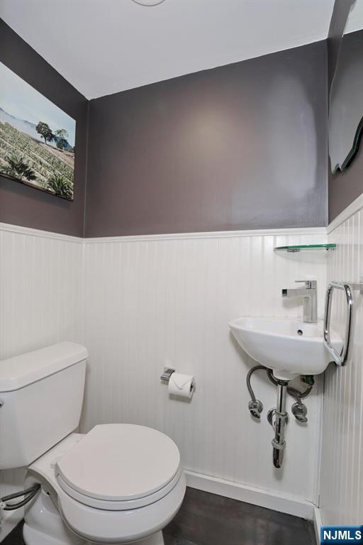 87 Barbara Road Dumont, NJ 07628 - Photo 35 of 48 a bathroom with a sink mirror and toilet