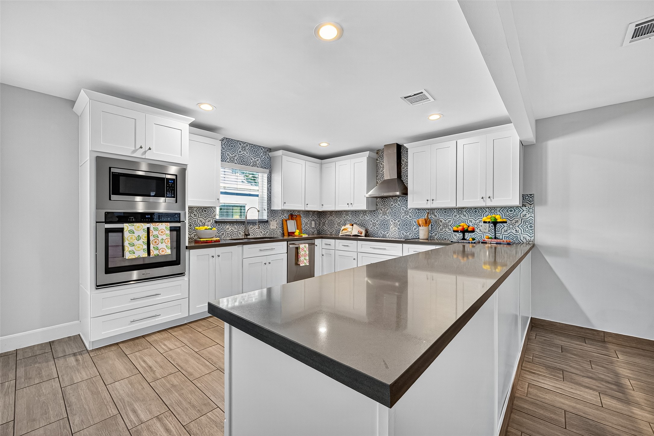 a large kitchen with granite countertop lots of counter space a sink and appliances
