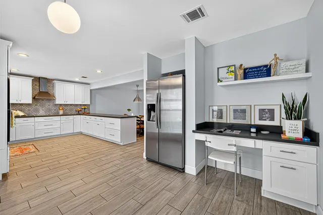 a kitchen with stainless steel appliances a refrigerator sink and cabinets