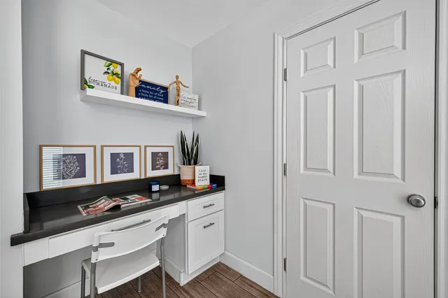 a living room with furniture cabinets and flat screen tv
