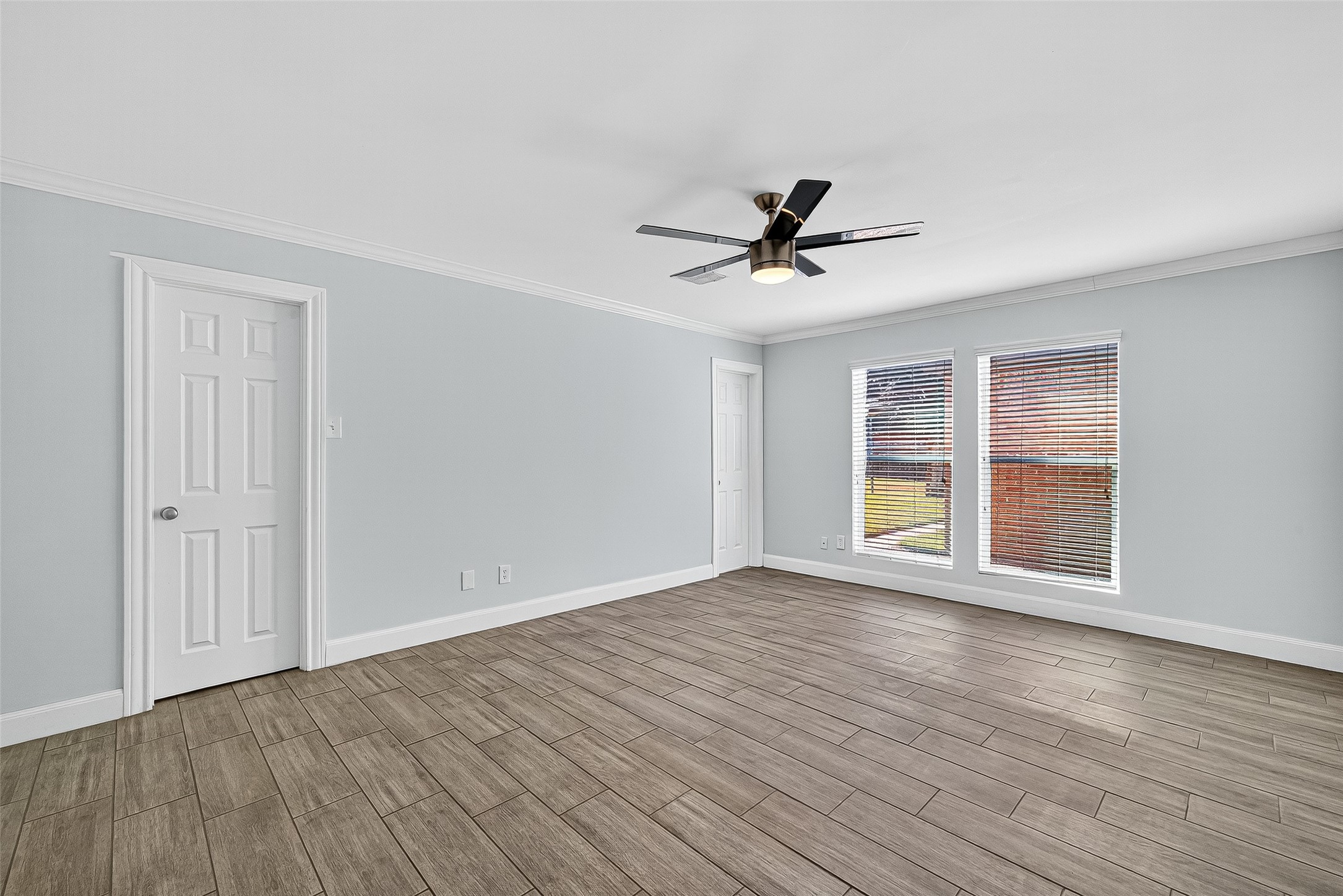 818 Silvergate Drive Houston, TX 77079 - Photo 21 of 40 a view of an empty room with a window and wooden floor