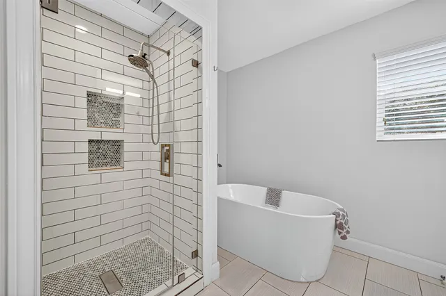 a bathroom with a bathtub and shower