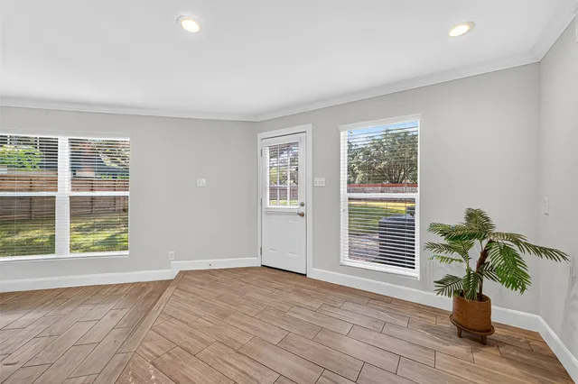 a view of an entryway with wooden floor and a window