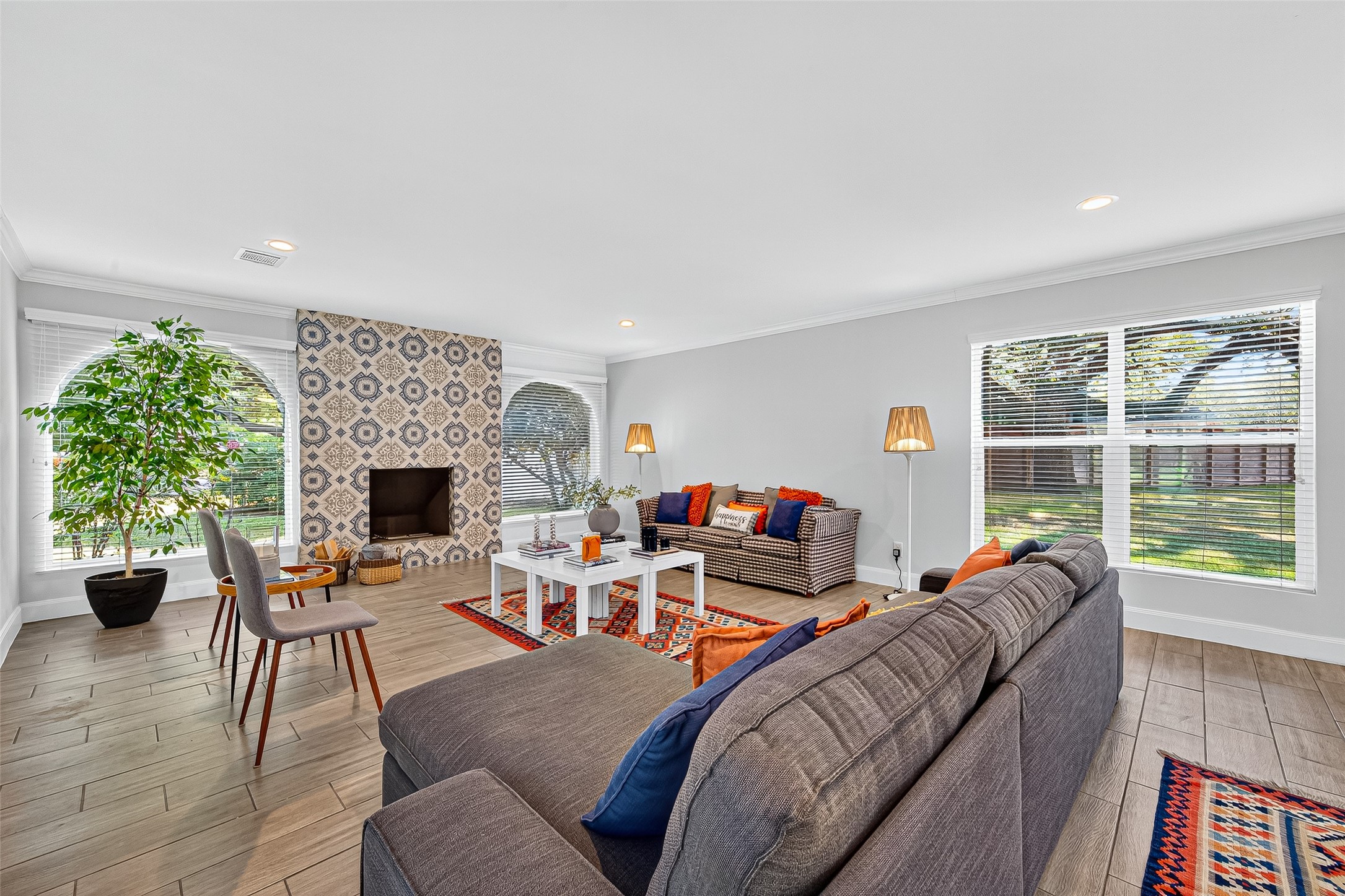 818 Silvergate Drive Houston, TX 77079 - Photo 5 of 40 a living room with furniture a fireplace and a floor to ceiling window