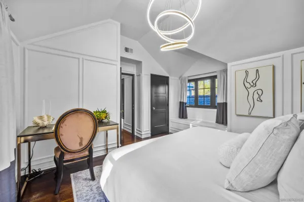 a bedroom with a large bed and potted plant