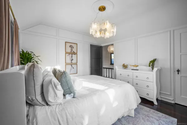 a bedroom with a large bed and a window