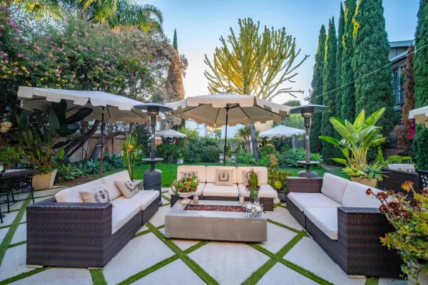 a view of a patio with a table and chairs under an umbrella