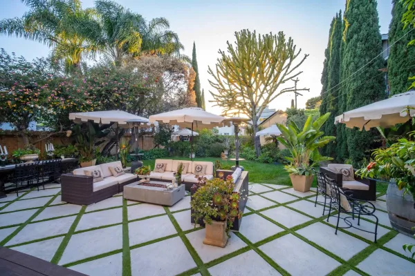 a view of a house with a backyard and a patio