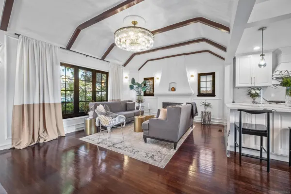 a living room with furniture and a large mirror