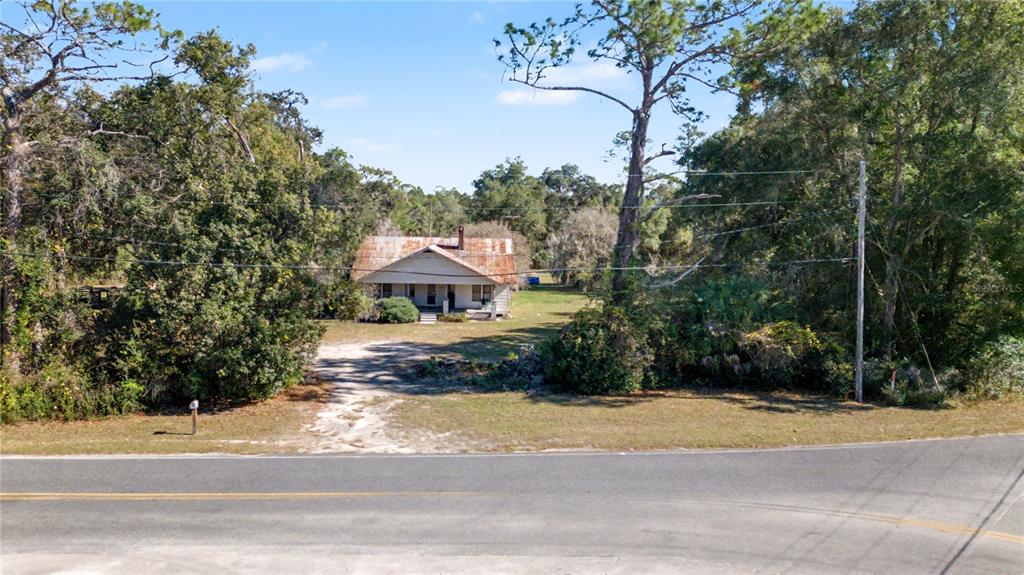 815 Northeast 145th Avenue Road Silver Springs, FL 34488 - Photo 11 of 42 a view of a house with a yard and large trees