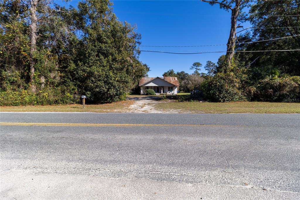 815 Northeast 145th Avenue Road Silver Springs, FL 34488 - Photo 13 of 42 a view of a house with a yard and garage