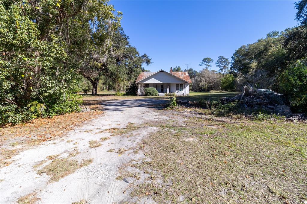 815 Northeast 145th Avenue Road Silver Springs, FL 34488 - Photo 20 of 42 a front view of a house with a yard