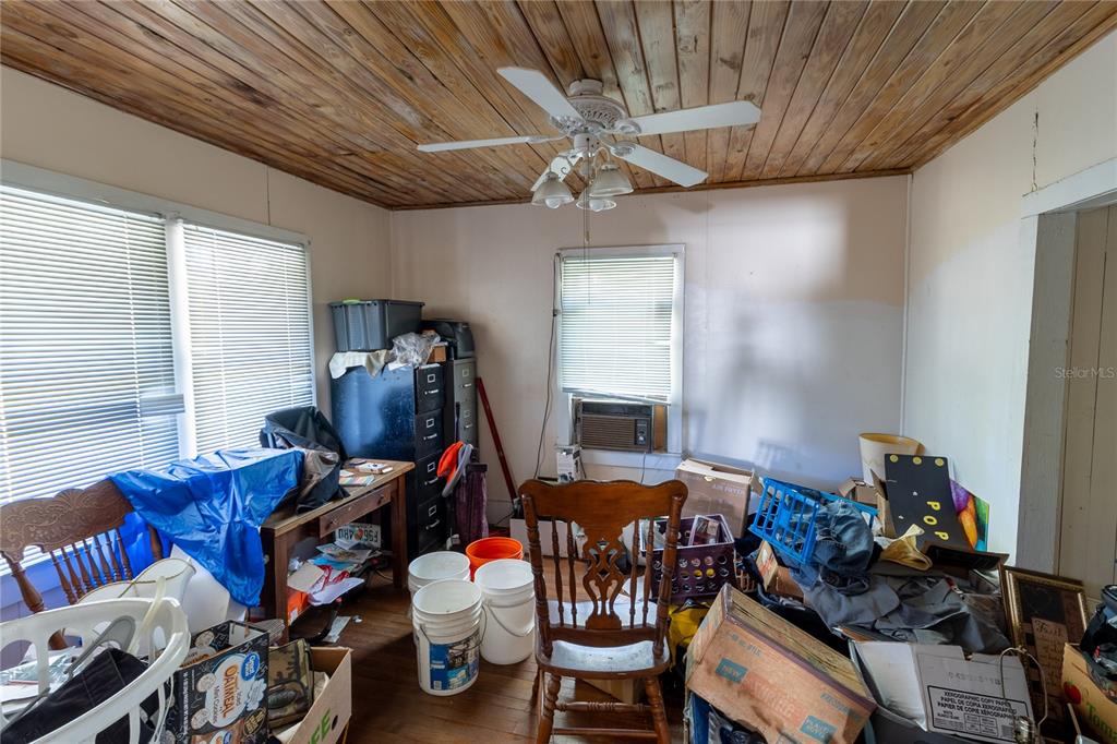 815 Northeast 145th Avenue Road Silver Springs, FL 34488 - Photo 29 of 42 a bedroom with furniture and a window