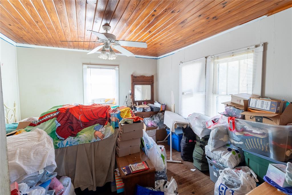 815 Northeast 145th Avenue Road Silver Springs, FL 34488 - Photo 32 of 42 a bed room with a bed and a chandelier