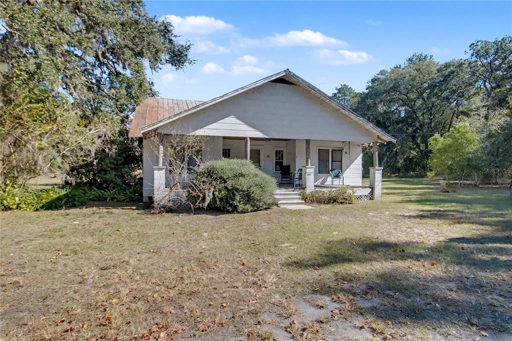 815 Northeast 145th Avenue Road Silver Springs, FL 34488 - Photo 40 of 42 a view of a house with a yard and large trees