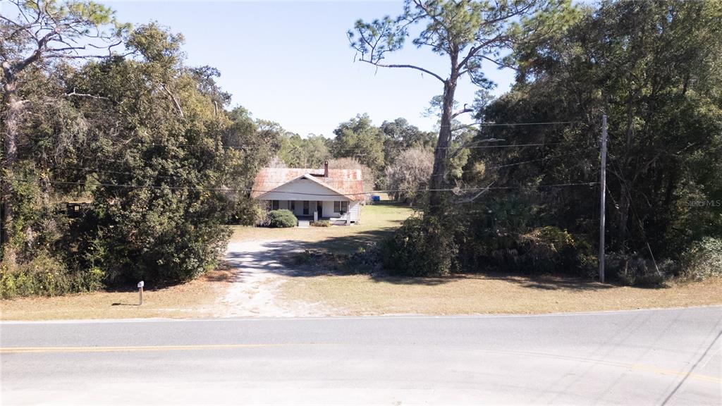 815 Northeast 145th Avenue Road Silver Springs, FL 34488 - Photo 5 of 42 a view of a yard and car parked