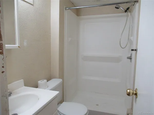 a bathroom with a toilet and a shower