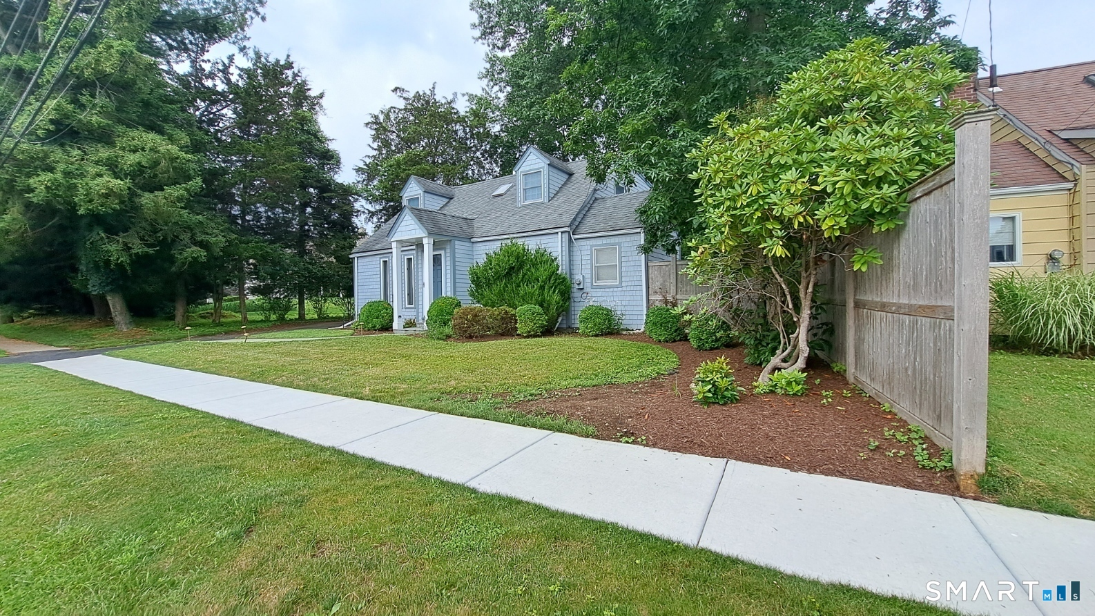 914 South Pine Creek Road, Unit A Fairfield, CT 06824 - Photo 2 of 15 a front view of a house with a yard
