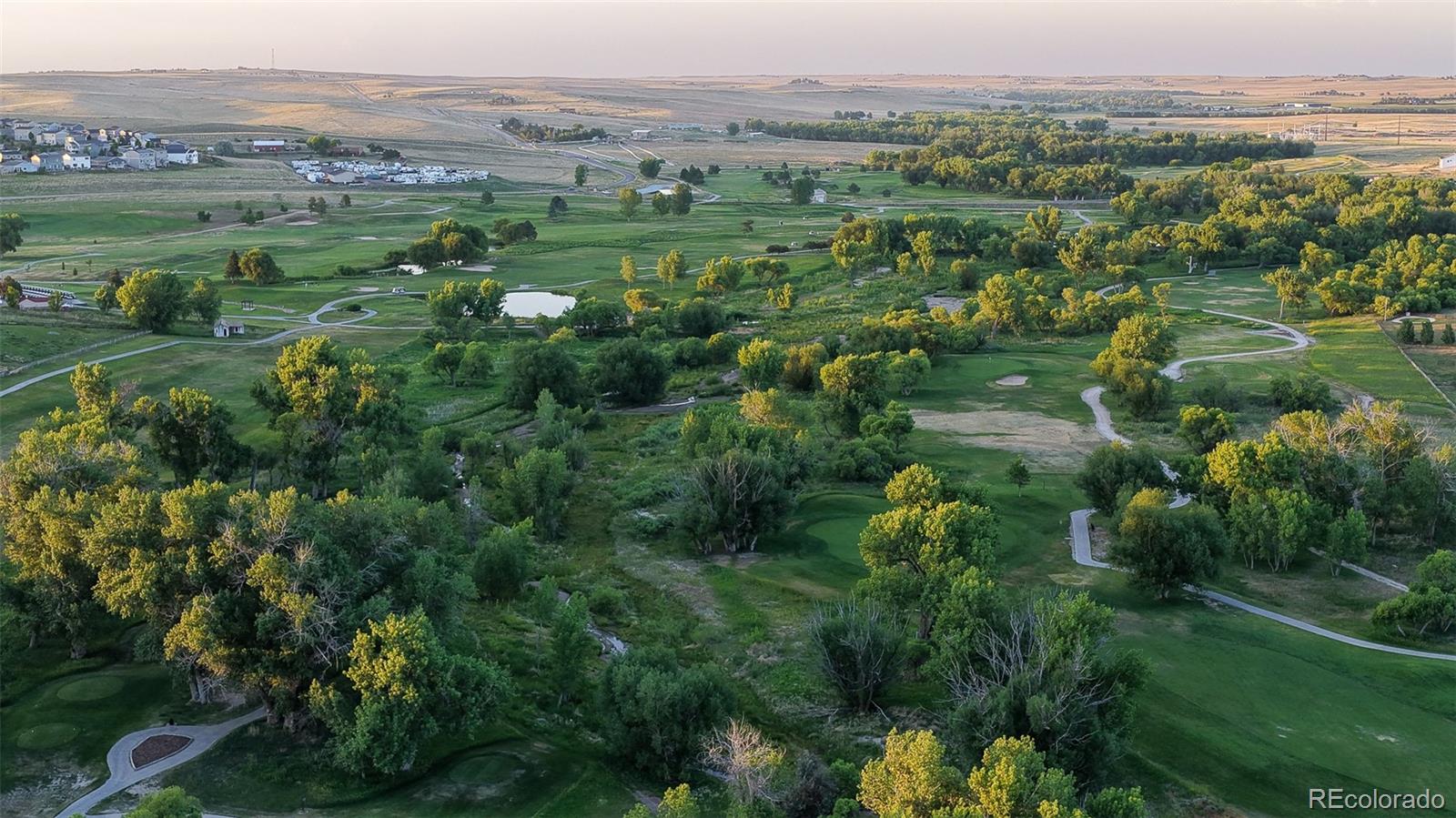 41865 East Muirfield Loop Elizabeth, CO 80107 - Photo 46 of 50 an aerial view of green landscape with trees and houses