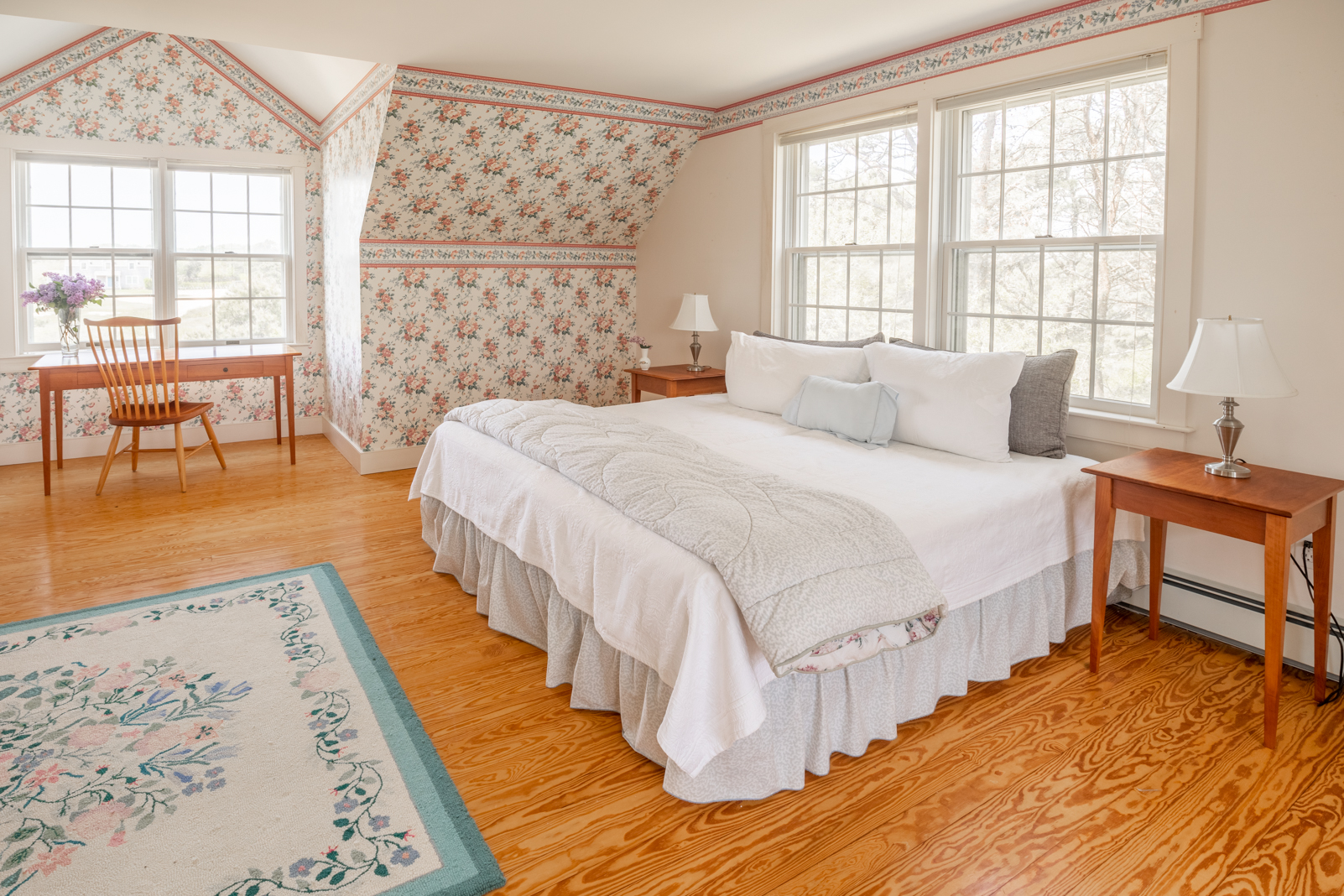 15 Swift Rock Road Nantucket, MA 02554 - Photo 30 of 32 a spacious bedroom with a bed a table and windows
