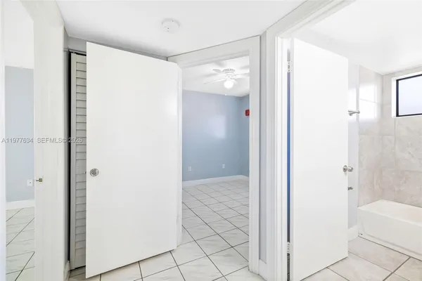 a view of bathroom with shower and closet