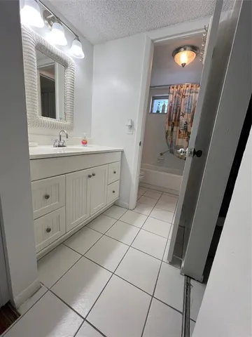 a spacious bathroom with a double vanity sink and a mirror
