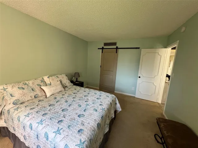 a bedroom with a bed and a chair
