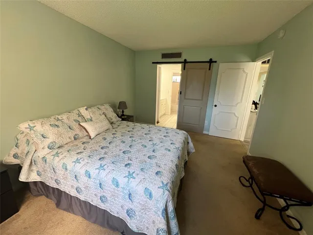a bedroom with a bed and a chair