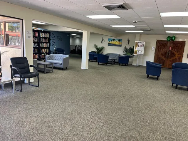 a living room with furniture and a bookshelf
