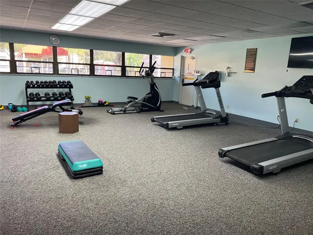 a room with gym equipment and a window