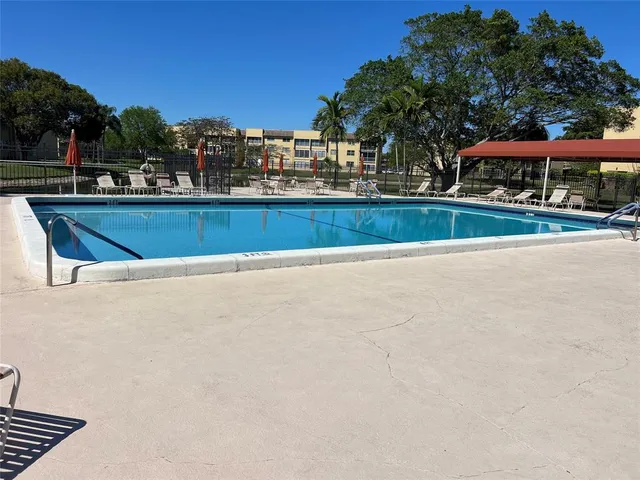a view of swimming pool with outdoor seating and yard