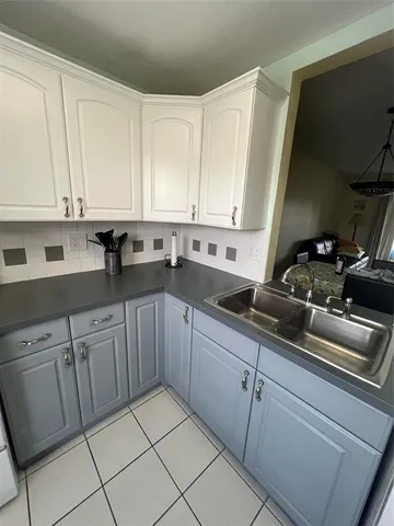 a kitchen with cabinets appliances and a sink