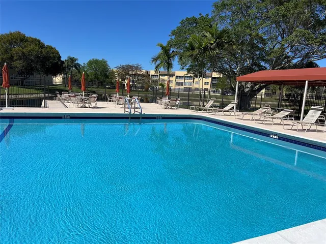 a view of outdoor space with swimming pool and furniture