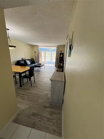 a living room with furniture a dining table and a piano table