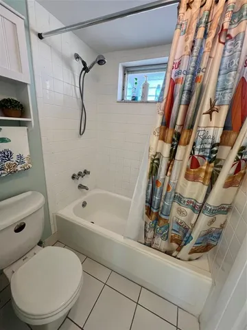 a bathroom with a toilet and a bathtub