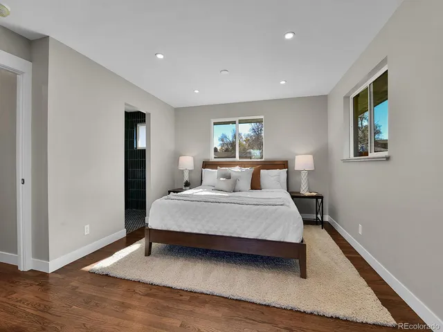 a spacious bedroom with a bed and a window