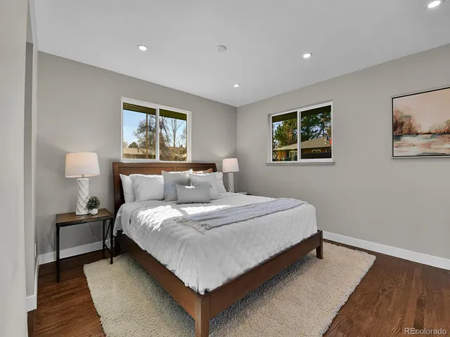 a bedroom with bed and night stand