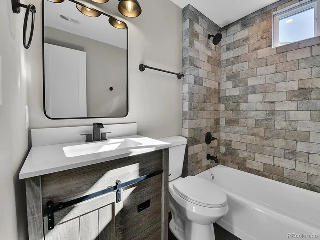 a bathroom with a sink a toilet and bathtub