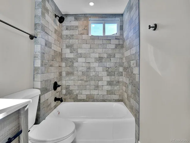 a bathroom with a toilet and bathtub
