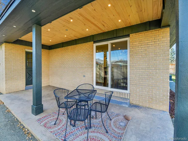 a view of a porch with chairs and backyard