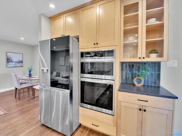 a kitchen with stainless steel appliances a stove a microwave and cabinets