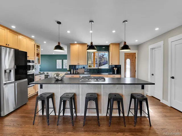 a large kitchen with a table and chairs