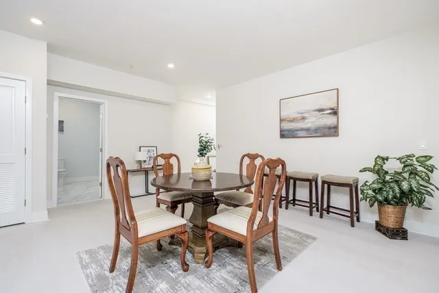 a view of a dining room with furniture and a potted plant