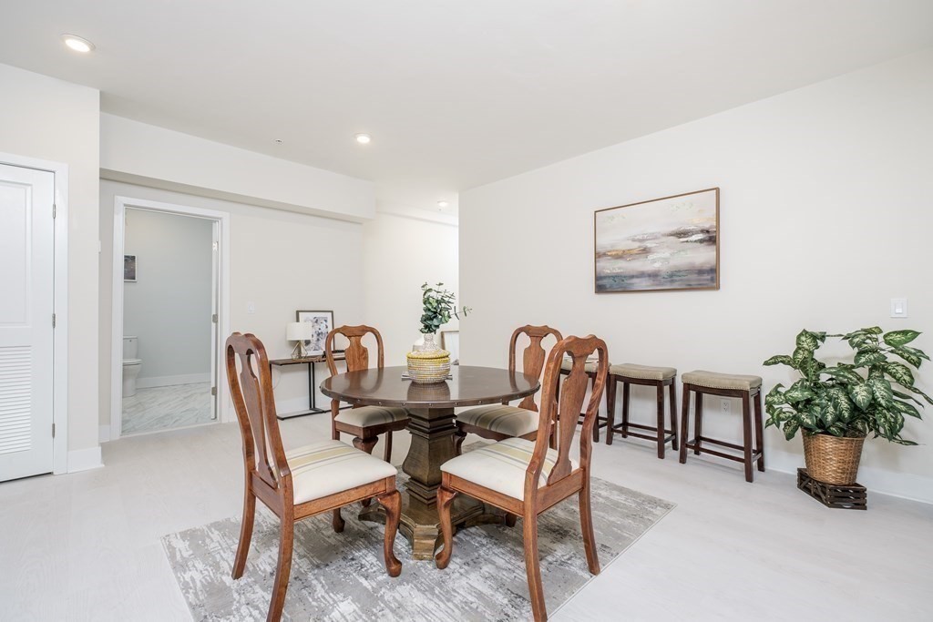 1540 North Shore Road, Unit 301 Revere, MA 02151 - Photo 12 of 14 a view of a dining room with furniture and a potted plant