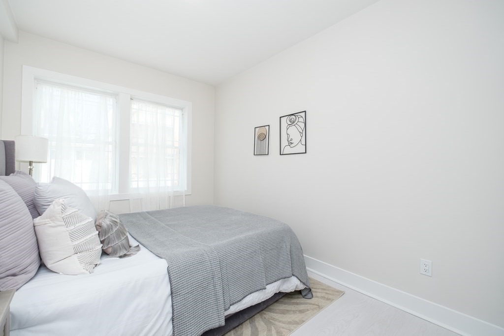 1540 North Shore Road, Unit 301 Revere, MA 02151 - Photo 9 of 14 a bedroom with a bed and a window