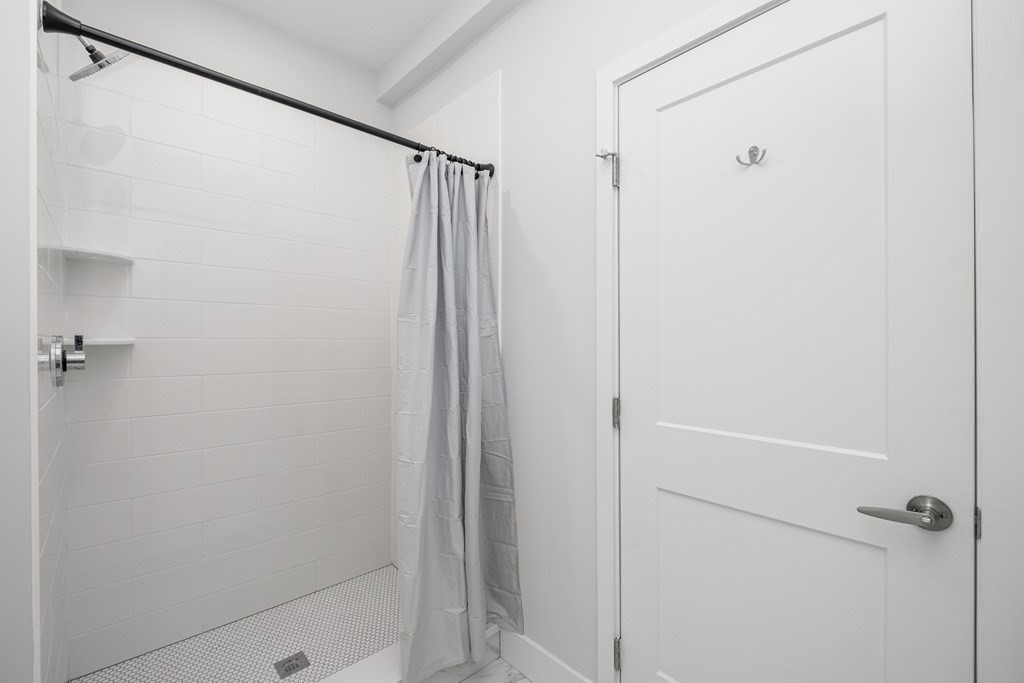 1540 North Shore Road, Unit 301 Revere, MA 02151 - Photo 10 of 14 a bathroom with a shower and a glass shower door