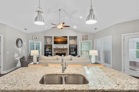 a view of a kitchen with a sink and a chandelier