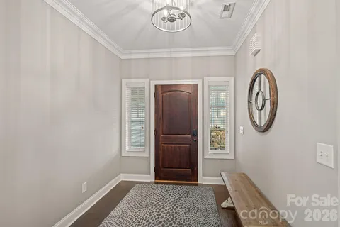 a view of a hallway with entryway wooden floor and front door