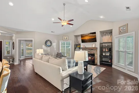 a living room with furniture a fireplace and a flat screen tv